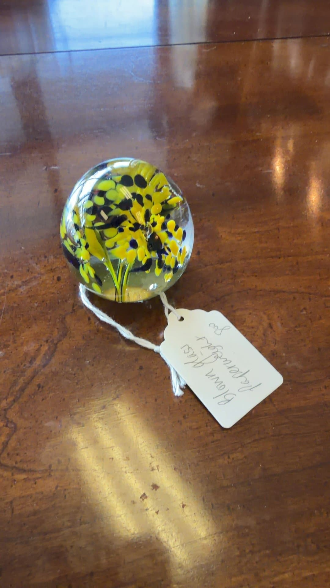 Blown Glass Paperweight with Yellow Floral Design - Image 1