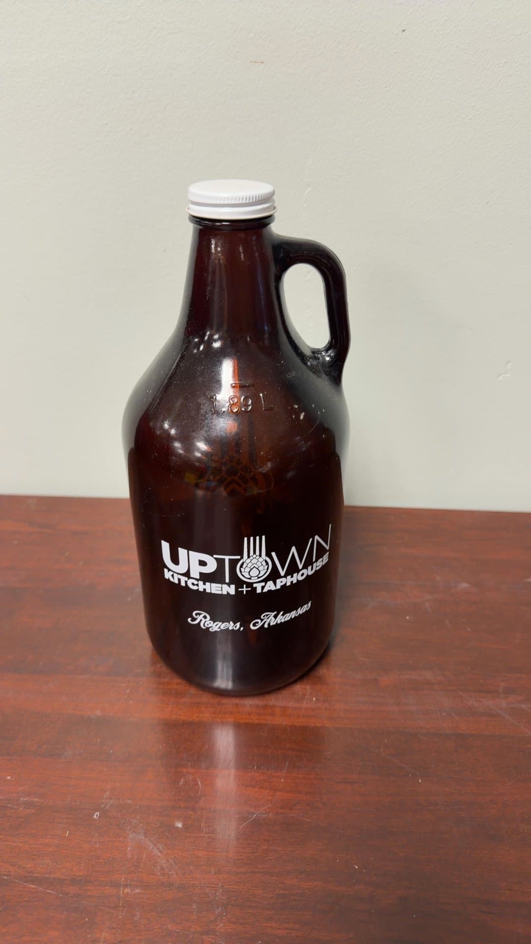 Uptown Kitchen + Taphouse Glass Growler - Image 1
